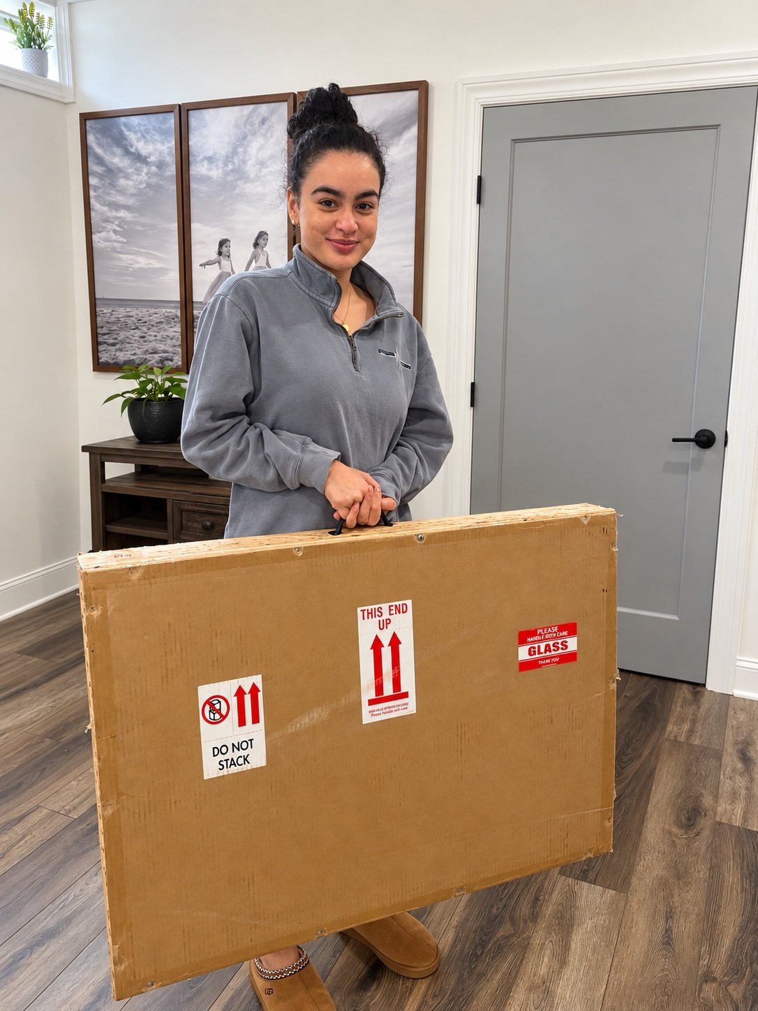 Graduation portrait client collecting her packaged Guild canvas in the studio