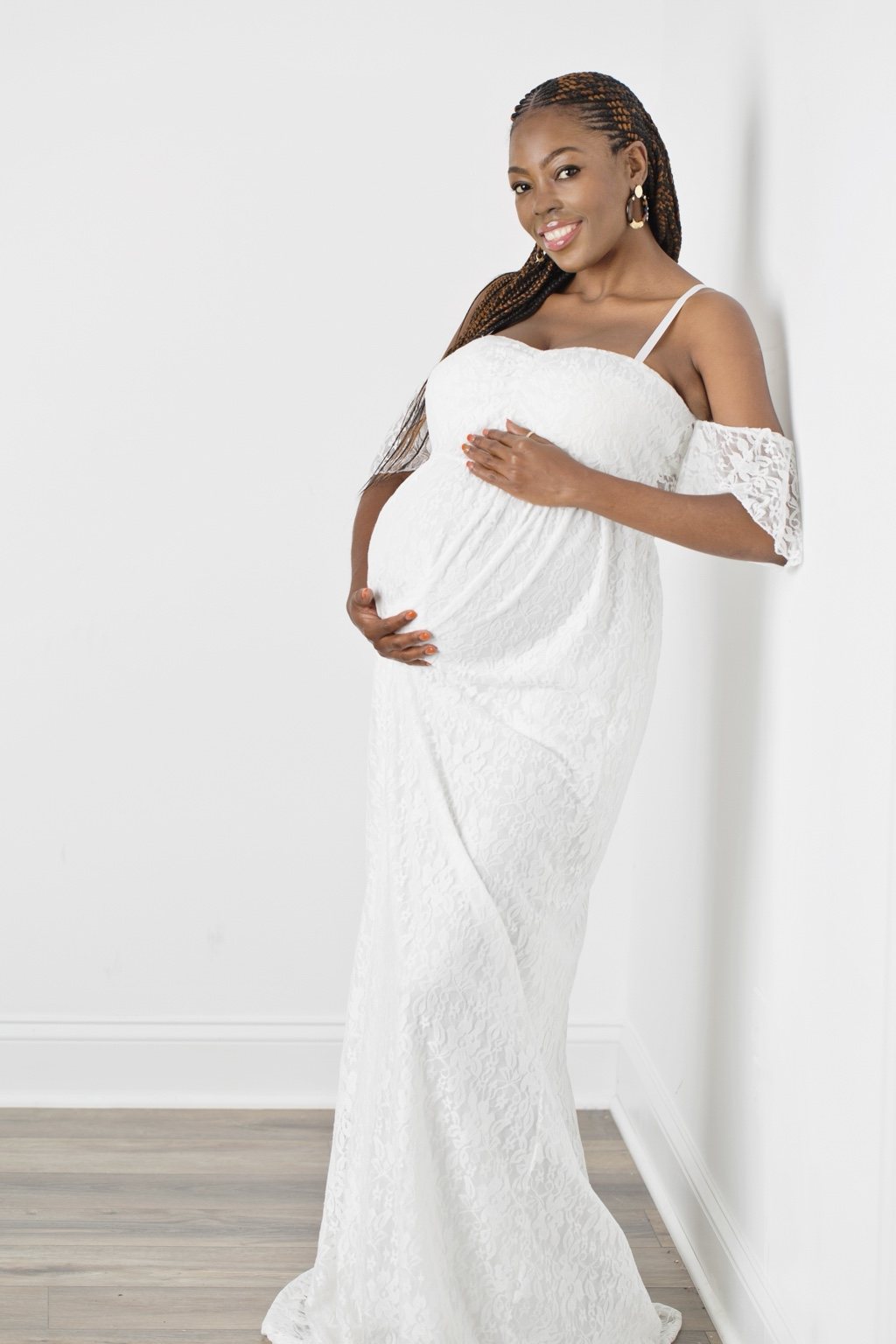 Maternity portrait in a white lace gown