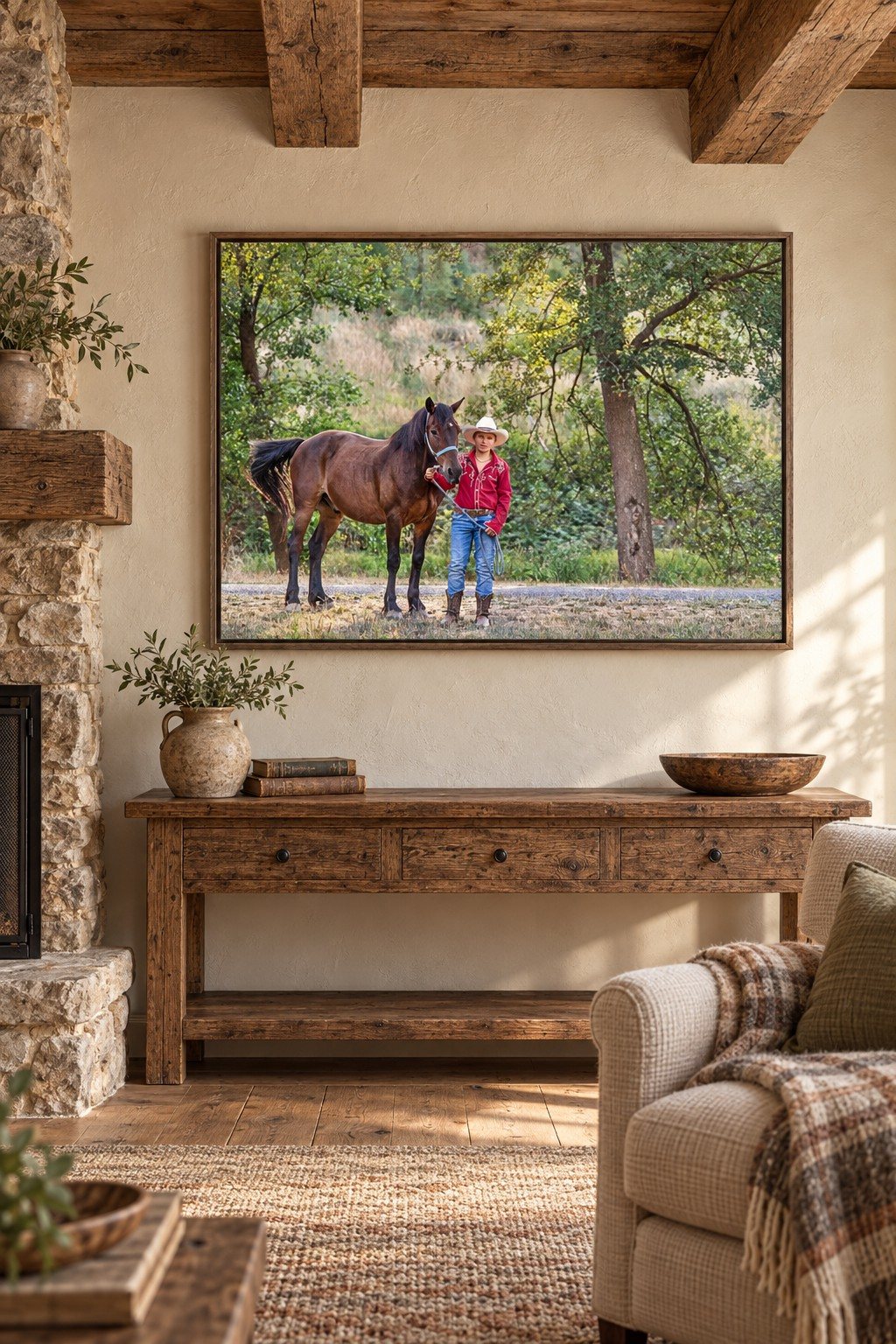 Color portrait of a boy and horse in a weathered wood frame in a rustic room with beams and a stone fireplace